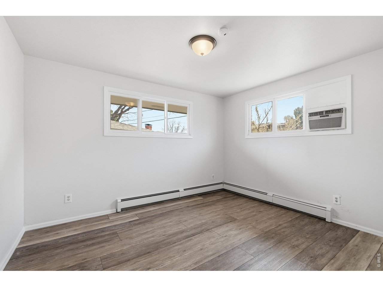 11590 West 39th Place Wheat Ridge, CO 80033 - Photo 18 of 37 a view of an empty room with wooden floor