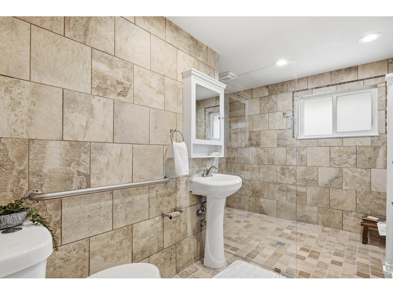 11590 West 39th Place Wheat Ridge, CO 80033 - Photo 19 of 37 a bathroom with a sink and a shower