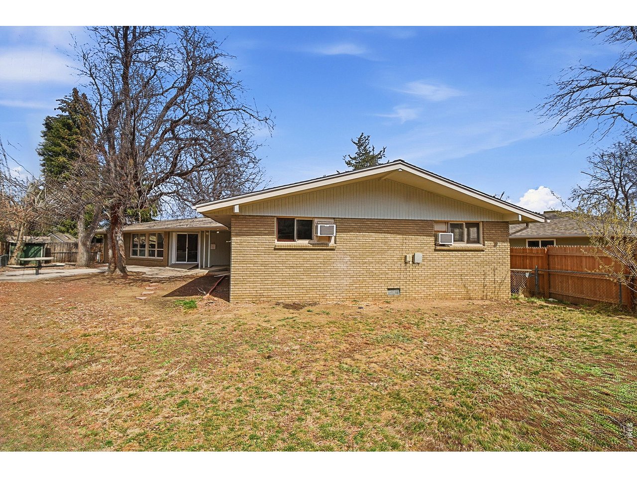 11590 West 39th Place Wheat Ridge, CO 80033 - Photo 26 of 37 a big house with a big yard and large trees