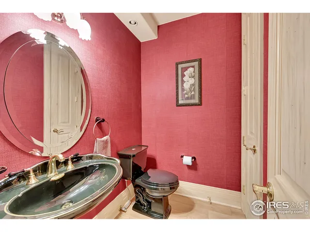 a bathroom with a sink mirror vanity and toilet