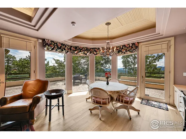 a dining room with furniture wooden floor and a chandelier