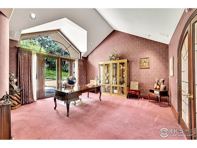 a living room with furniture and large windows