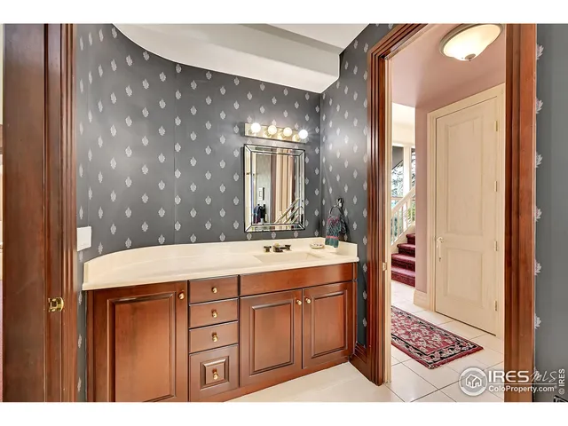 a bathroom with a sink a mirror and a shower