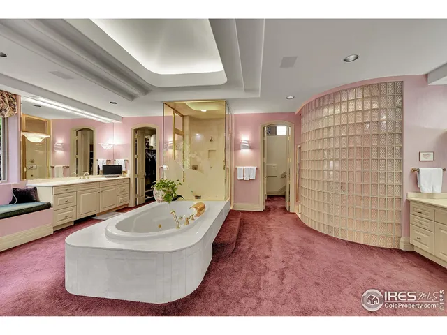 a spacious bathroom with a tub shower and mirror