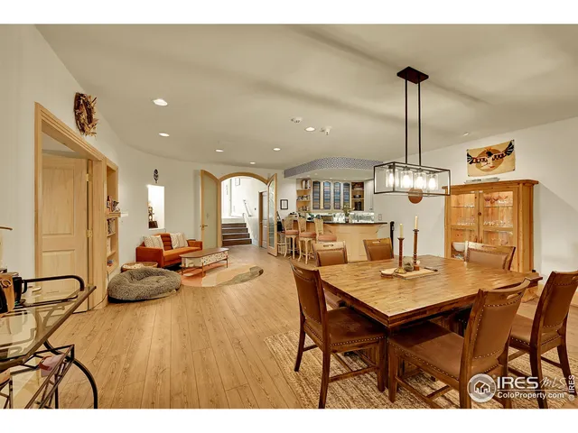 a open kitchen with stainless steel appliances kitchen island granite countertop a table and chairs