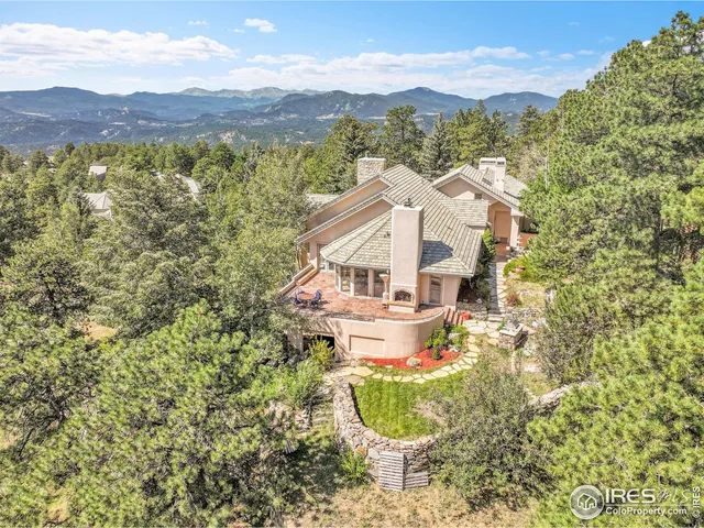 a view of a house with a yard and mountain