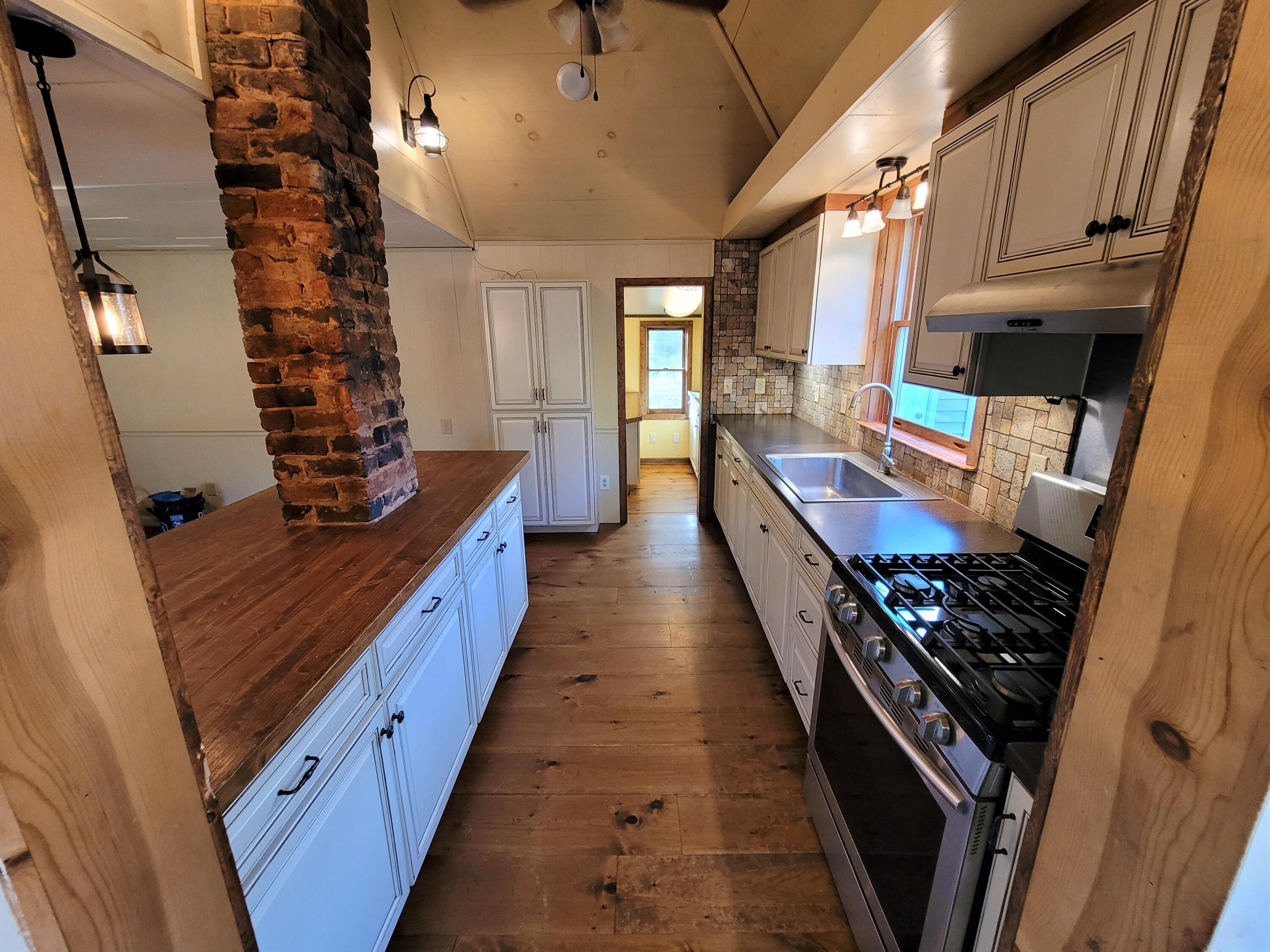 330 Green Level Road Boones Mill, VA 24065 - Photo 11 of 43 a kitchen with sink stove and cabinets