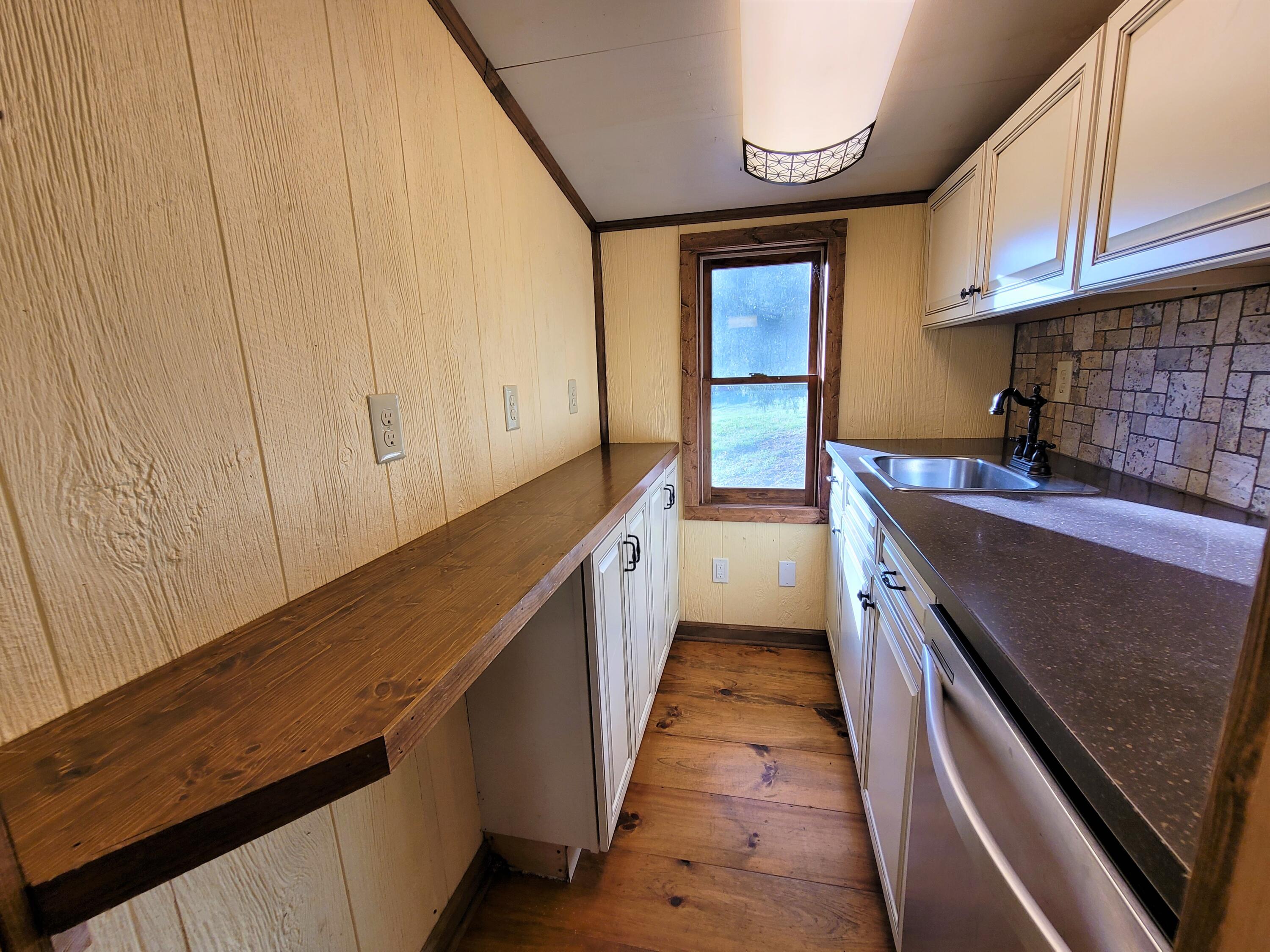 330 Green Level Road Boones Mill, VA 24065 - Photo 14 of 43 a kitchen with granite countertop sink stainless steel appliances and cabinets