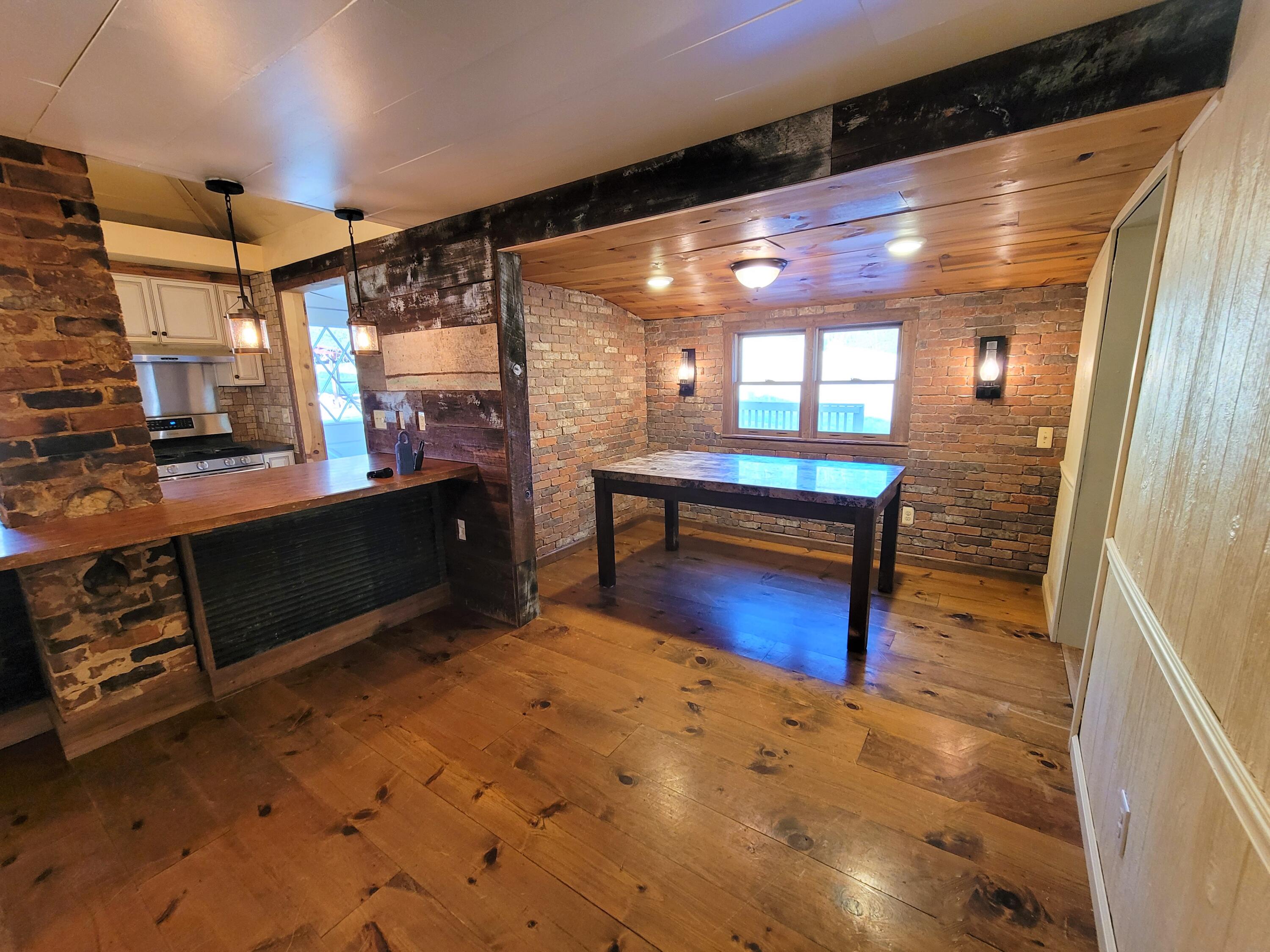 330 Green Level Road Boones Mill, VA 24065 - Photo 16 of 43 a room with wooden floor and furniture