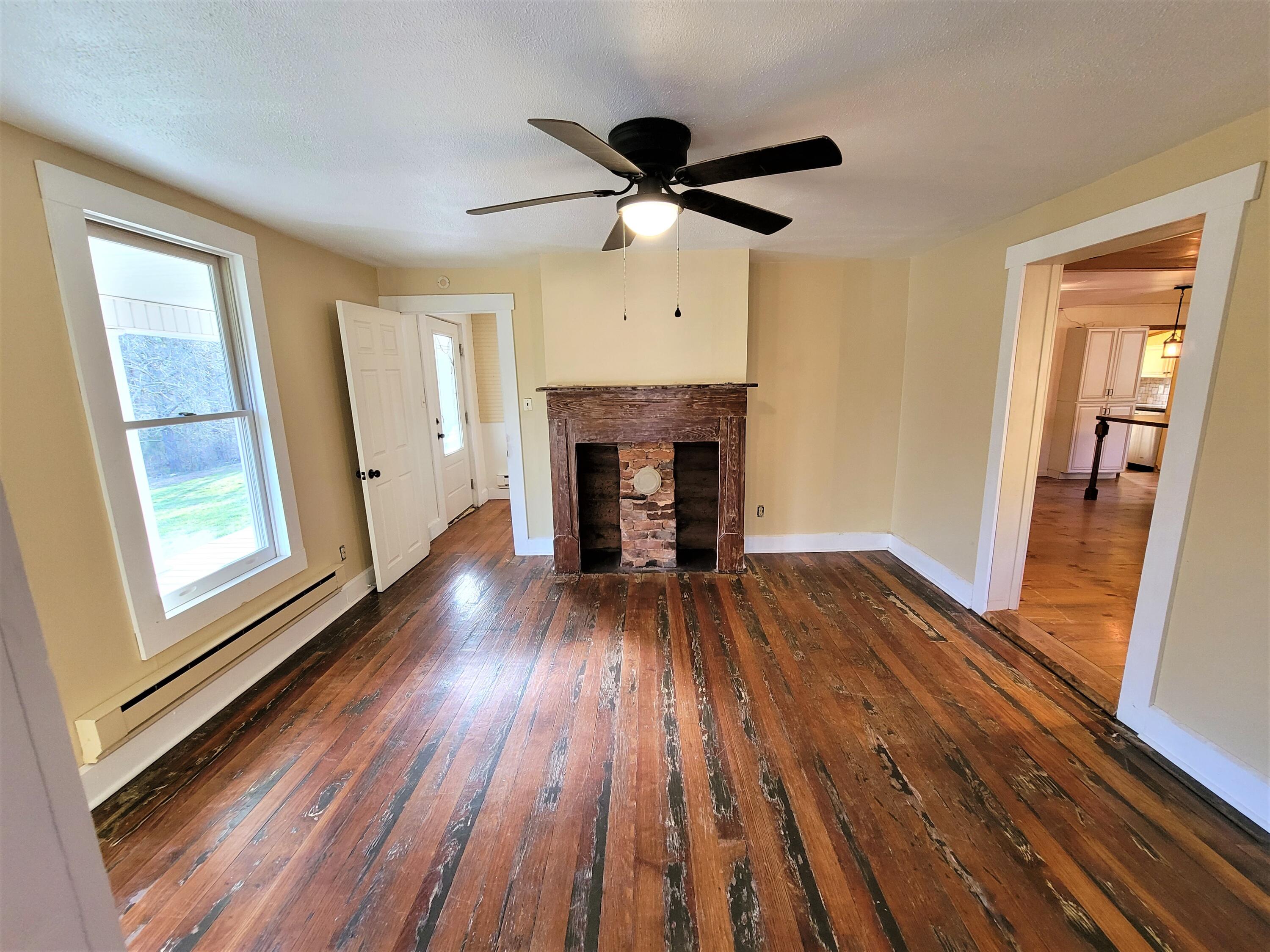 330 Green Level Road Boones Mill, VA 24065 - Photo 18 of 43 a view of empty room with wooden floor and fireplace