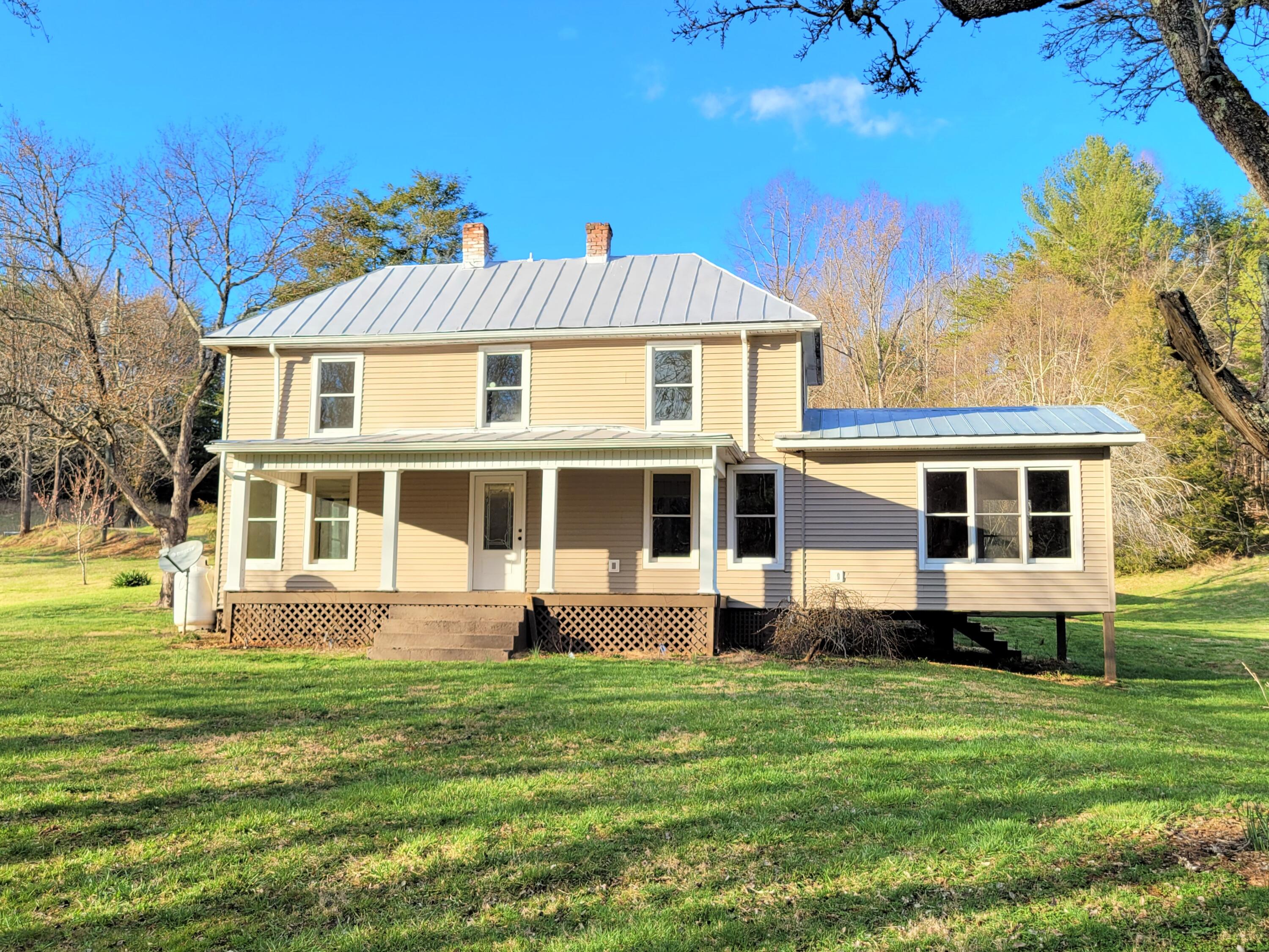 330 Green Level Road Boones Mill, VA 24065 - Photo 2 of 43 a front view of a house with a yard table and chairs