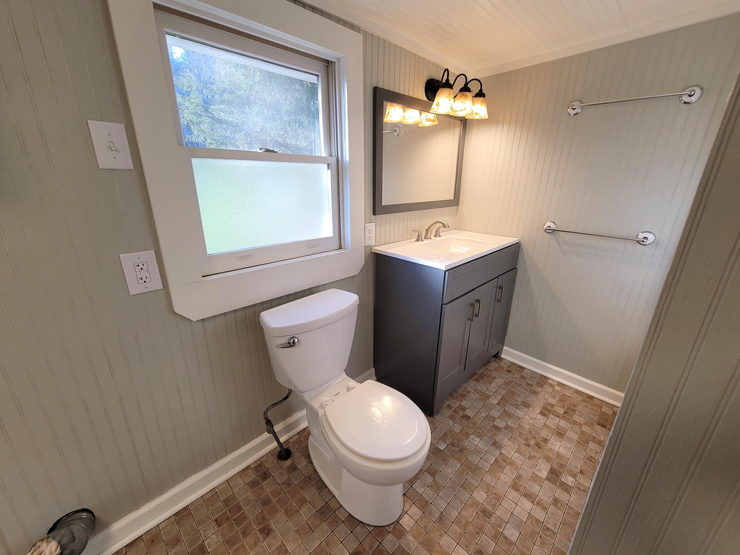 330 Green Level Road Boones Mill, VA 24065 - Photo 22 of 43 a bathroom with a toilet sink and mirror