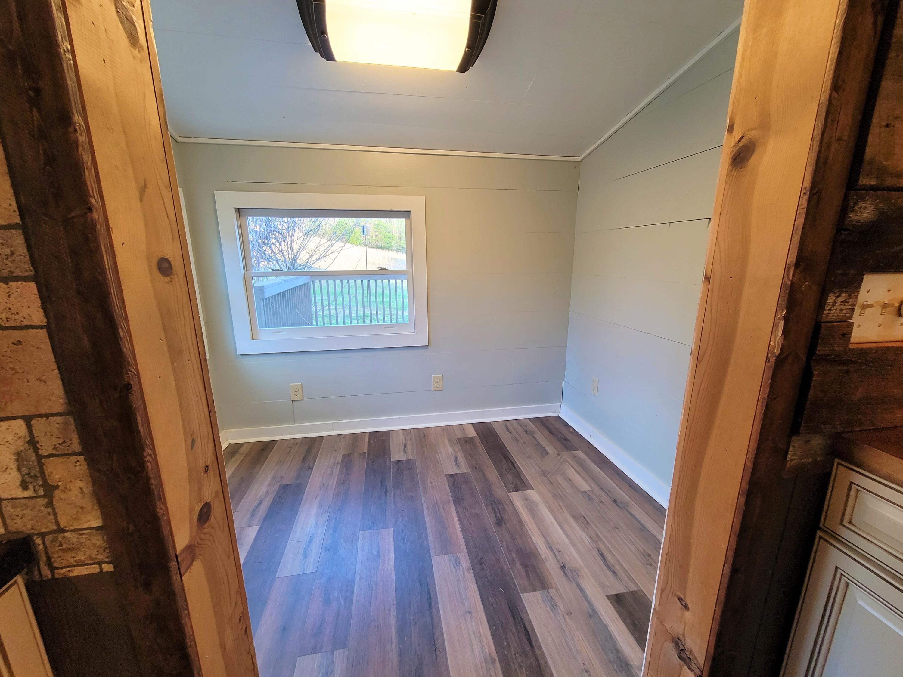 330 Green Level Road Boones Mill, VA 24065 - Photo 31 of 43 a view of an empty room with wooden floor and a window