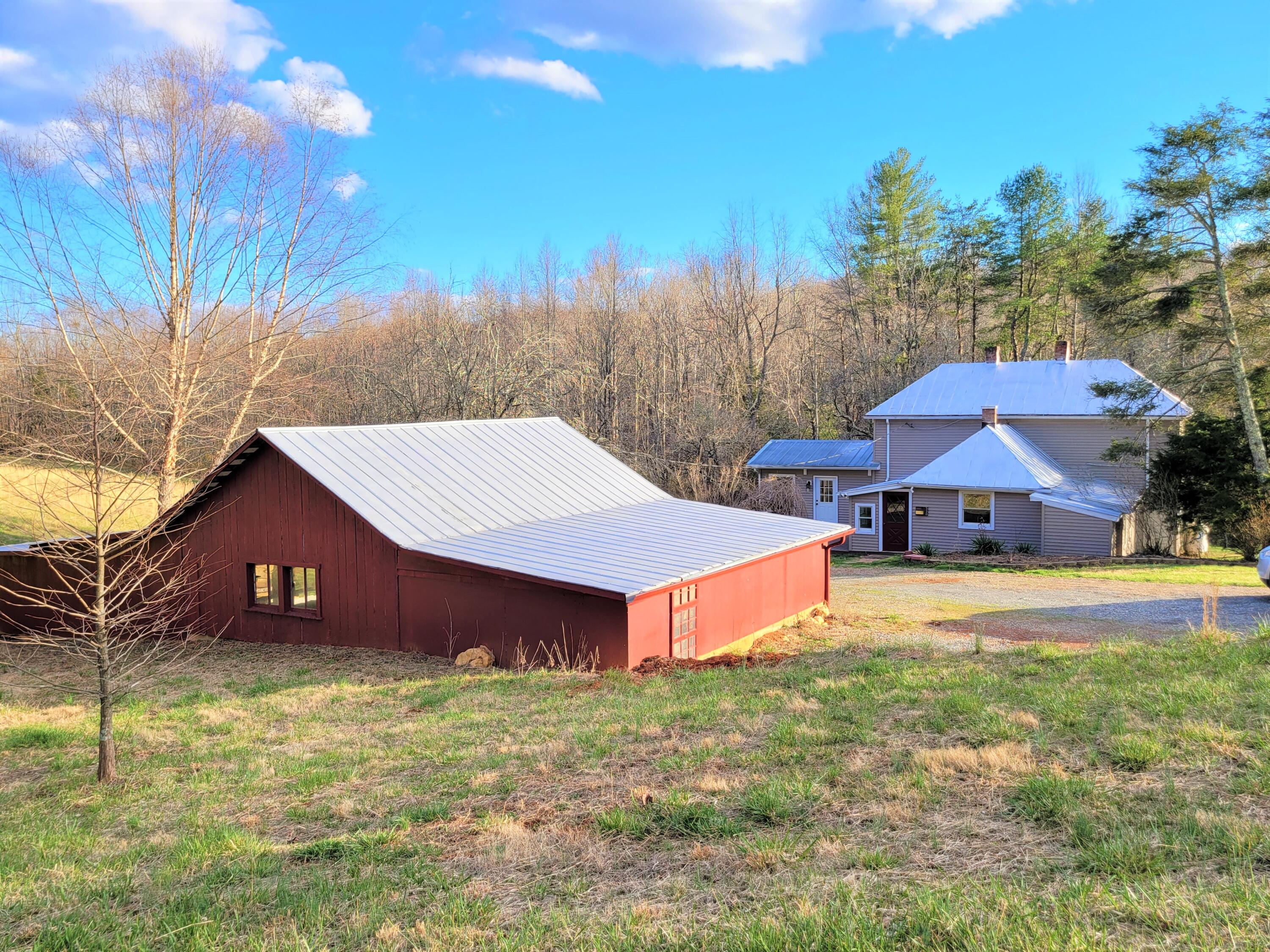 330 Green Level Road Boones Mill, VA 24065 - Photo 32 of 43 a front view of a house with a yard and large tree