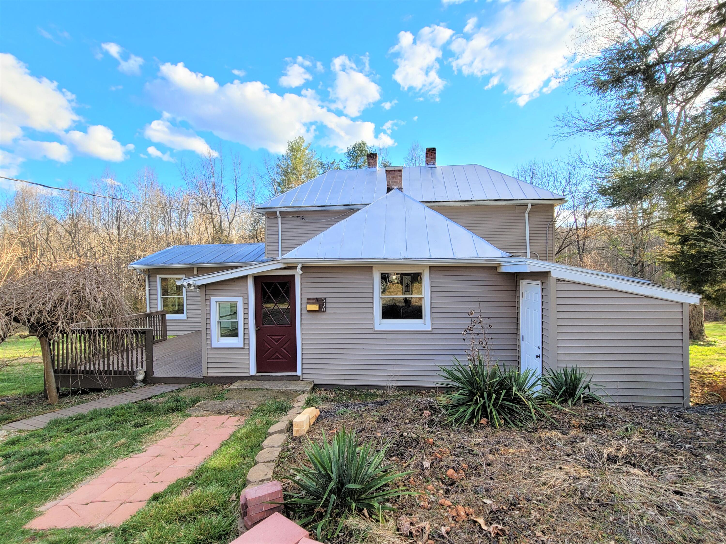 330 Green Level Road Boones Mill, VA 24065 - Photo 5 of 43 a front view of a house with yard