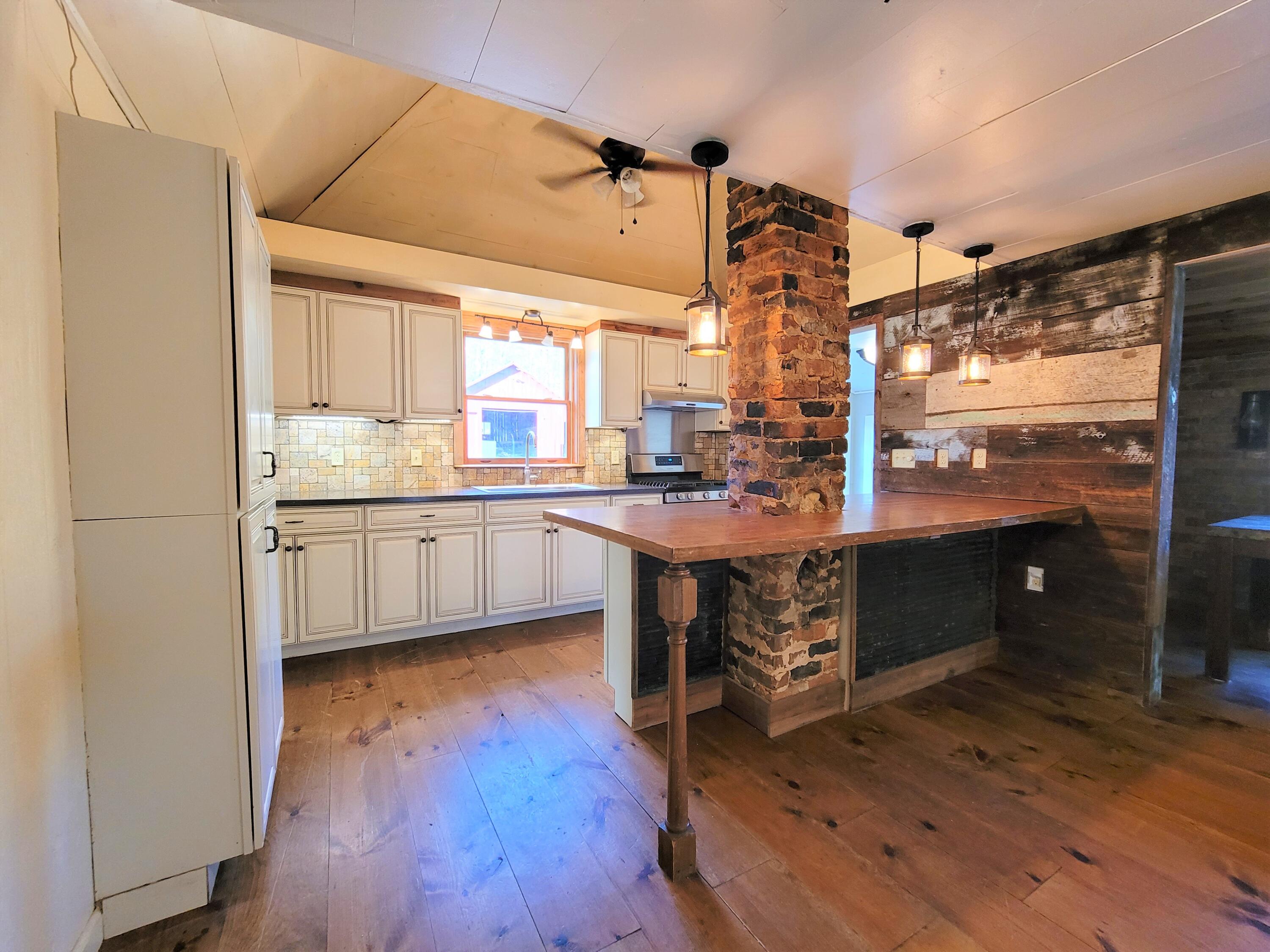 330 Green Level Road Boones Mill, VA 24065 - Photo 9 of 43 a kitchen with a sink cabinets and wooden floor