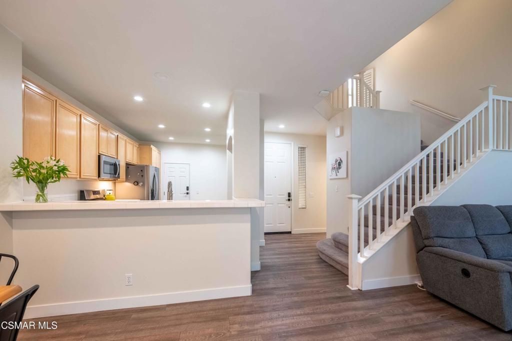 580 Fenwick Way, Unit C Simi Valley, CA 93065 - Photo 5 of 39 a living room with stainless steel appliances kitchen island granite countertop wooden floor and a view of kitchen