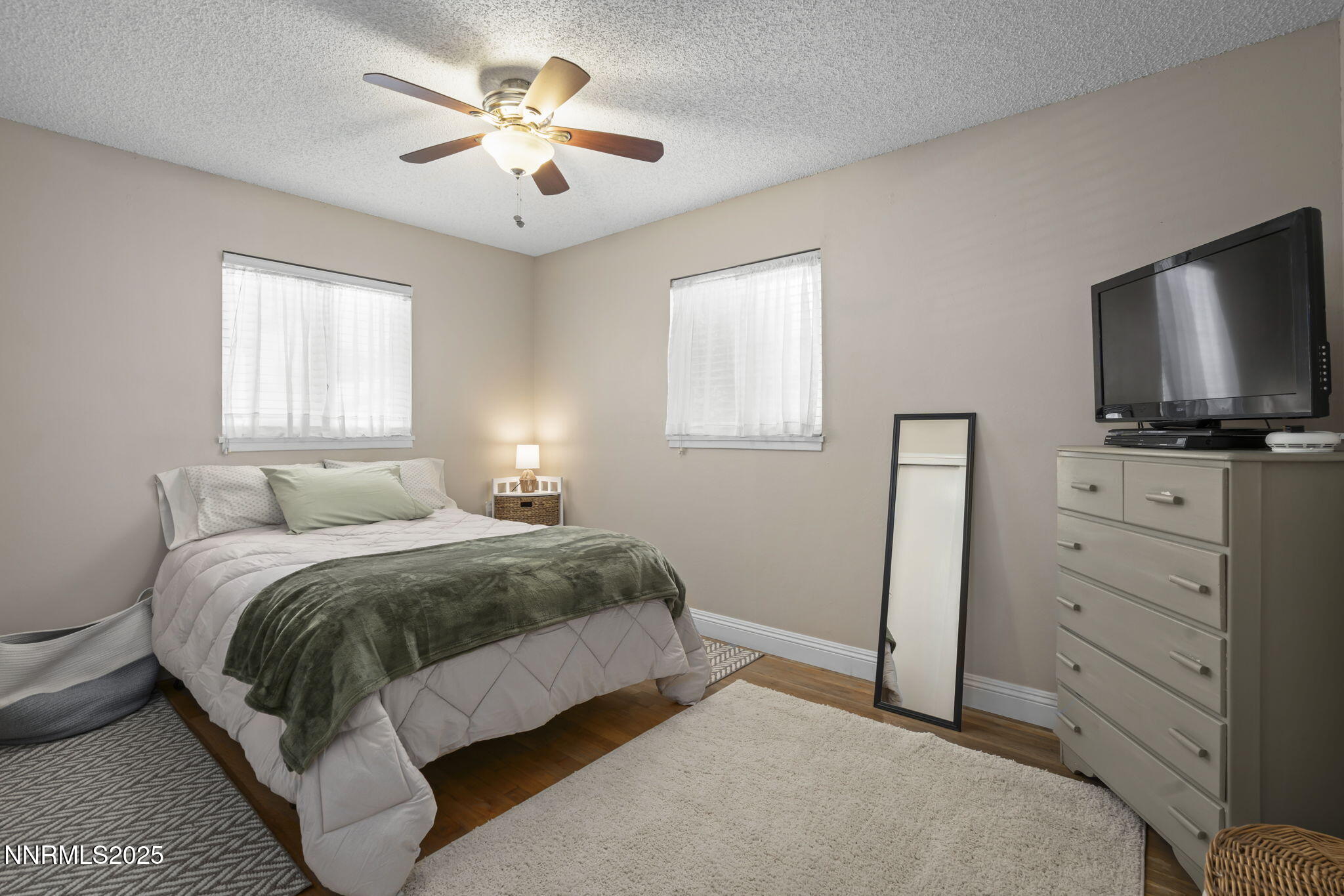 1680 Sutro Street Reno, NV 89512 - Photo 16 of 25 a spacious bedroom with a bed and a flat screen tv