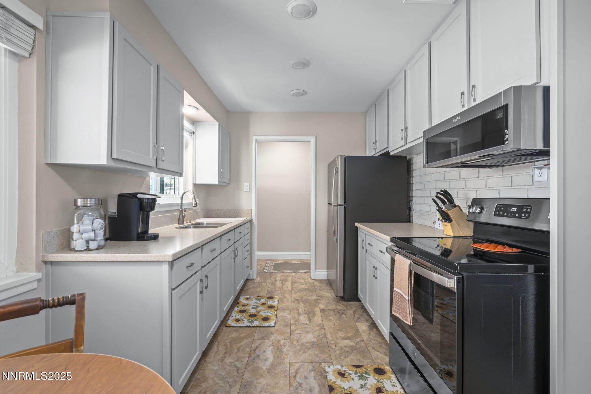 1680 Sutro Street Reno, NV 89512 - Photo 5 of 25 a kitchen with stainless steel appliances granite countertop a refrigerator a stove top oven a sink and dishwasher