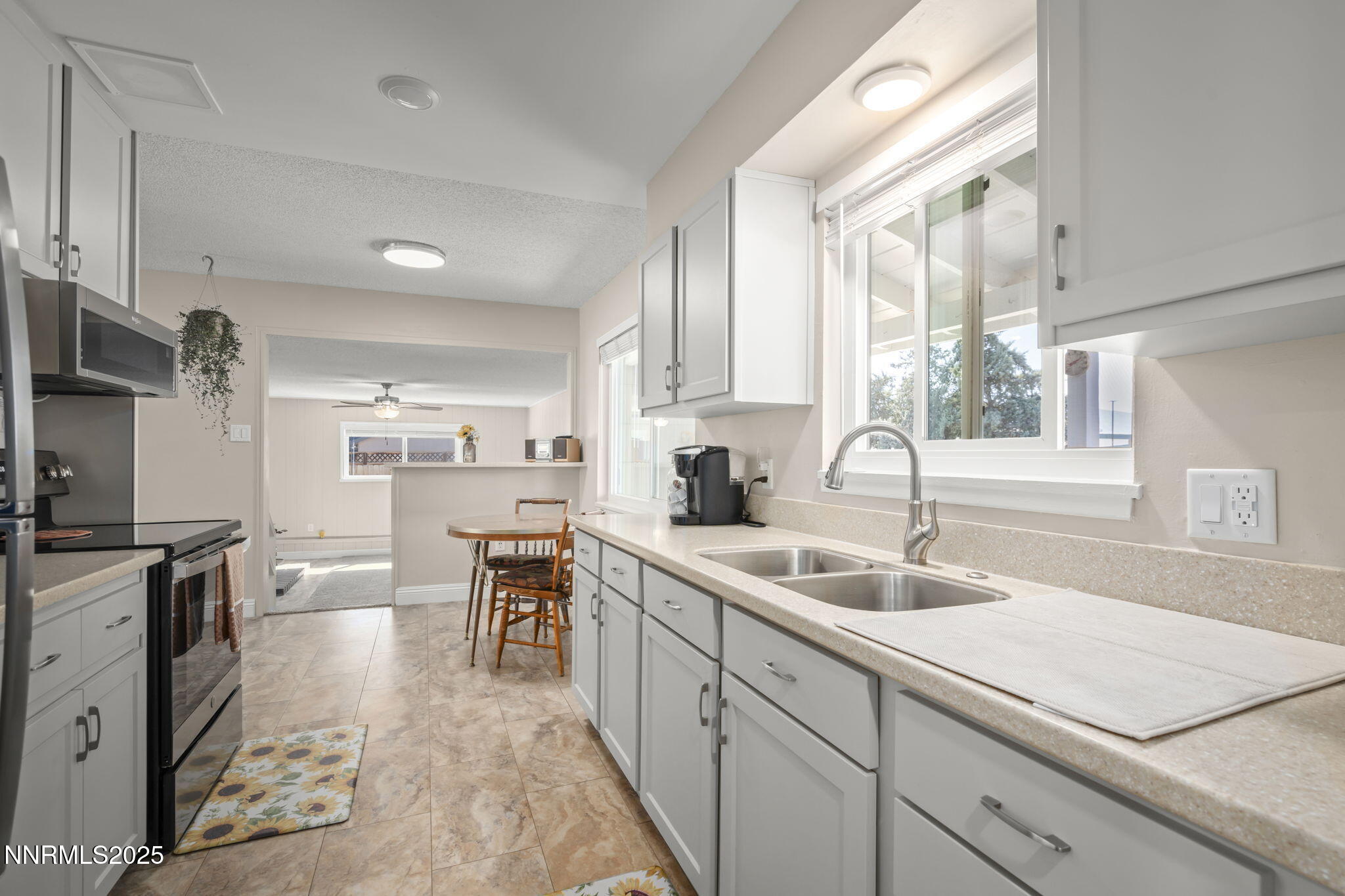 1680 Sutro Street Reno, NV 89512 - Photo 6 of 25 a kitchen with a sink stove and cabinets