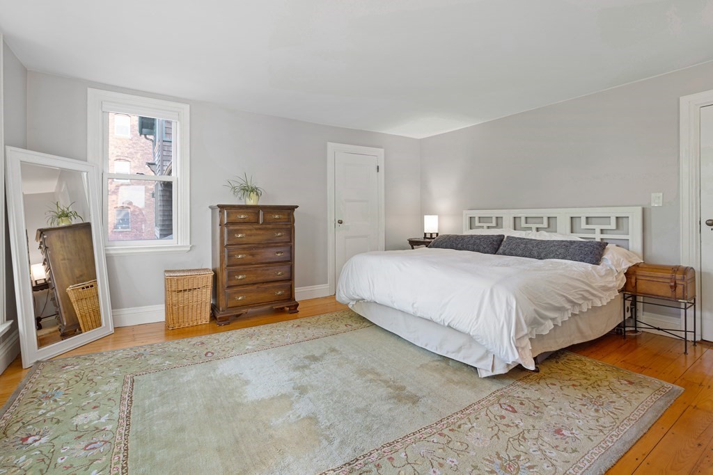 157 Winthrop Road, Unit 1 Brookline, MA 02445 - Photo 15 of 36 a bedroom with a bed and a television