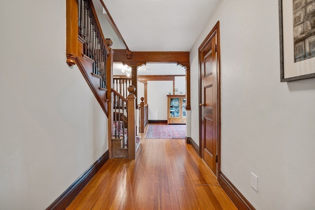 157 Winthrop Road, Unit 1 Brookline, MA 02445 - Photo 28 of 36 a view of a hallway with wooden floor and staircase