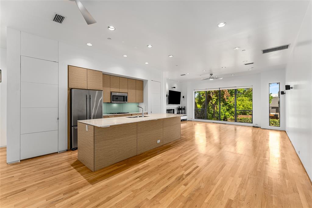 1505 North Haskell Avenue, Unit 5 Dallas, TX 75204 - Photo 13 of 40 a large kitchen with kitchen island a sink stainless steel appliances and cabinets
