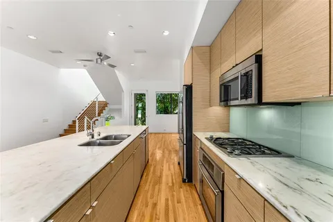 a kitchen with sink stove and refrigerator