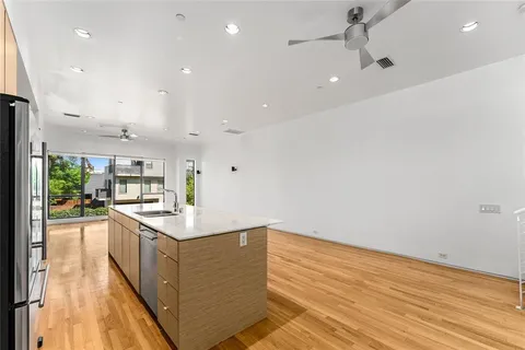 a kitchen with stainless steel appliances granite countertop a sink and cabinets