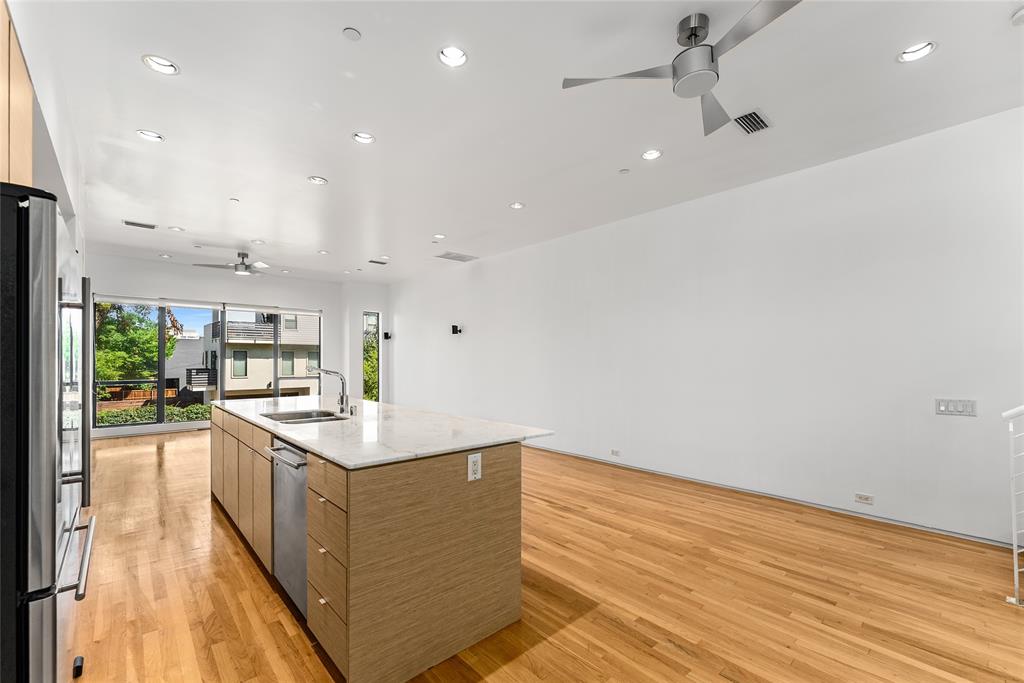 1505 North Haskell Avenue, Unit 5 Dallas, TX 75204 - Photo 16 of 40 a kitchen with stainless steel appliances granite countertop a sink and cabinets