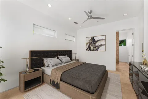 a bedroom with bed and a chandelier