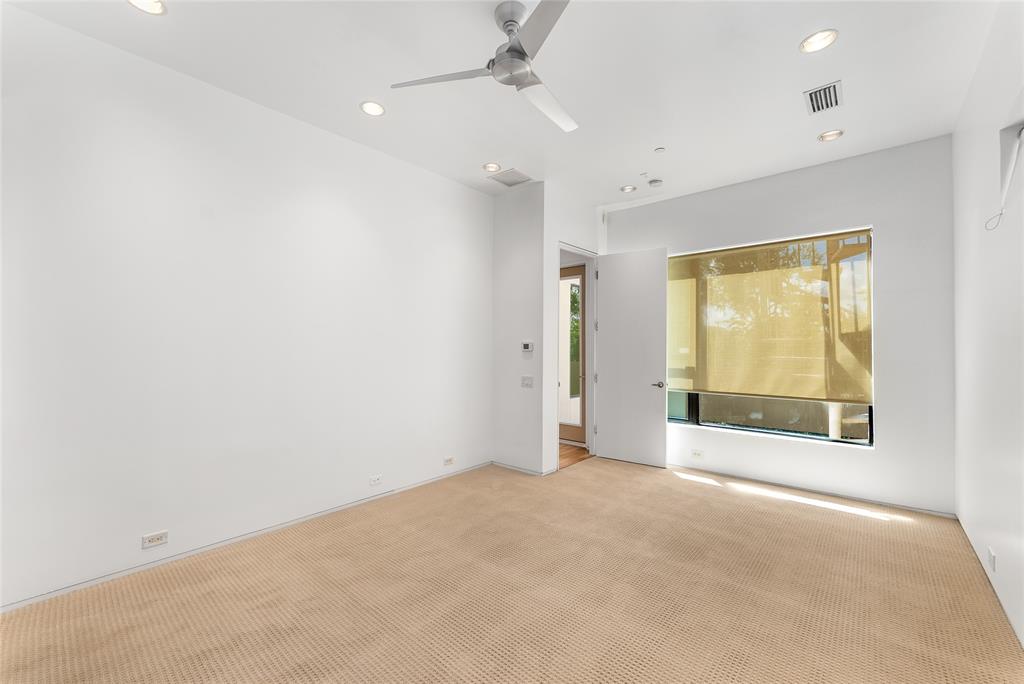 1505 North Haskell Avenue, Unit 5 Dallas, TX 75204 - Photo 22 of 40 an empty room with a fireplace and windows