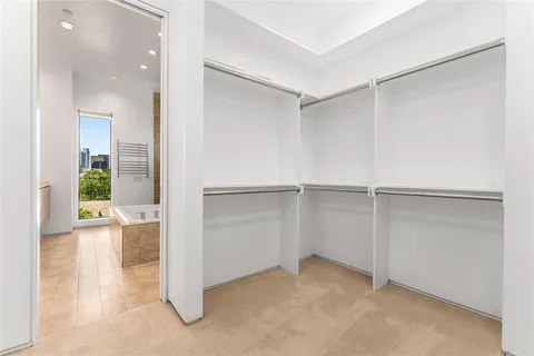 an empty room with cabinet and mirrors