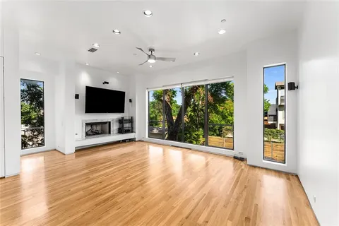 a view of a livingroom with wooden floor and a flat screen tv