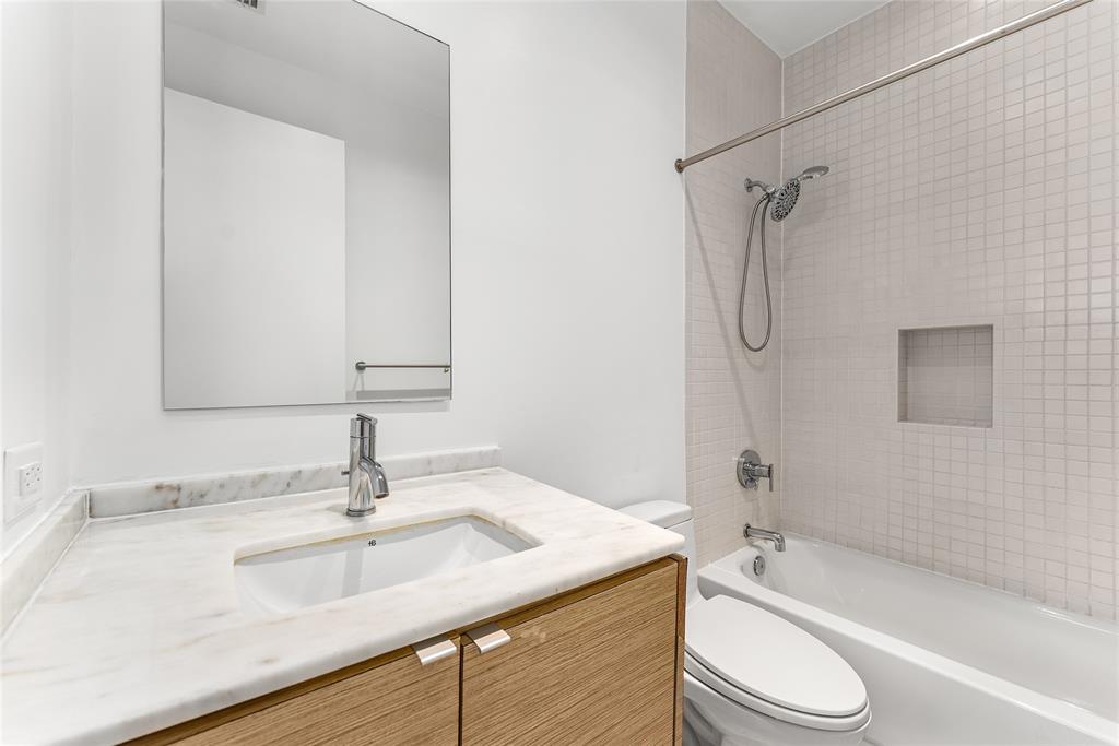 1505 North Haskell Avenue, Unit 5 Dallas, TX 75204 - Photo 35 of 40 a bathroom with a sink a toilet and shower