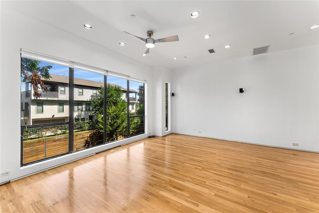 1505 North Haskell Avenue, Unit 5 Dallas, TX 75204 - Photo 7 of 40 an empty room with wooden floor and windows