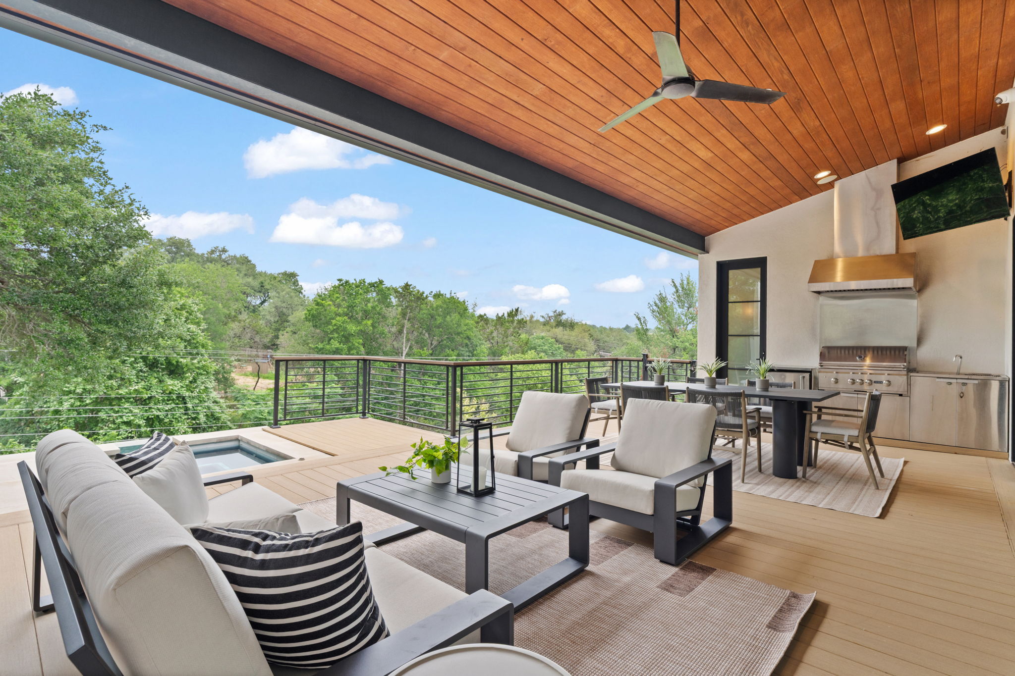 604 Brookhaven Trail Austin, TX 78746 - Photo 27 of 38 The outdoor living area right off of the living room and kitchen on the main level. Featuring a built in grill.
