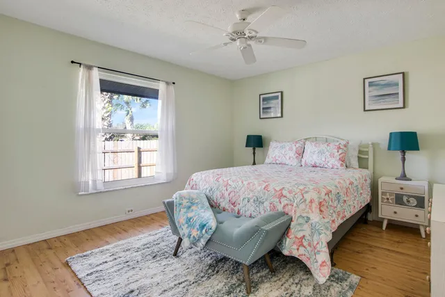a spacious bedroom with a bed and a dresser