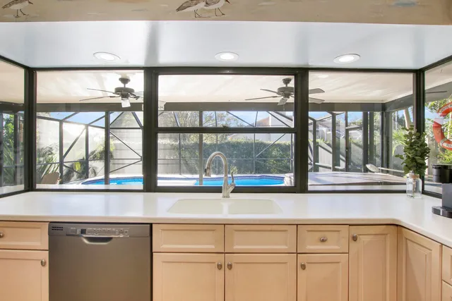 a kitchen with a refrigerator and a stove top oven