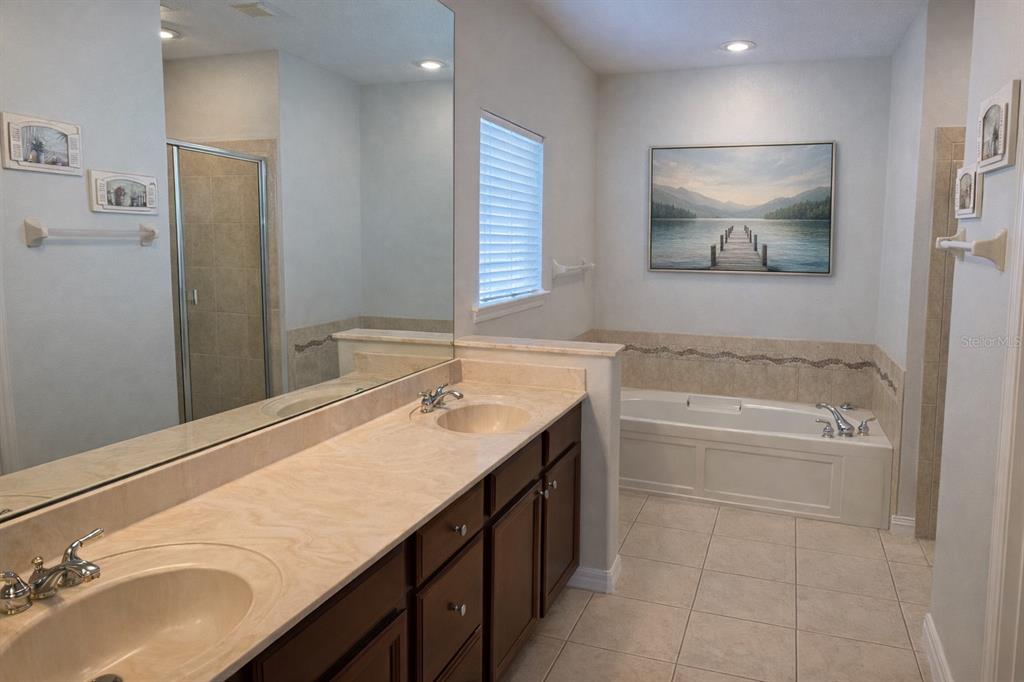 1007 Bennett Road Orlando, FL 32814 - Photo 13 of 25 a bathroom with a tub sink and mirror