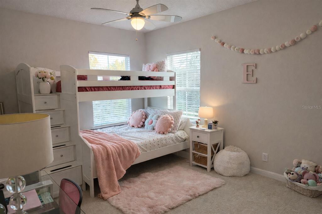 1007 Bennett Road Orlando, FL 32814 - Photo 15 of 25 a bedroom with a bed and a chandelier