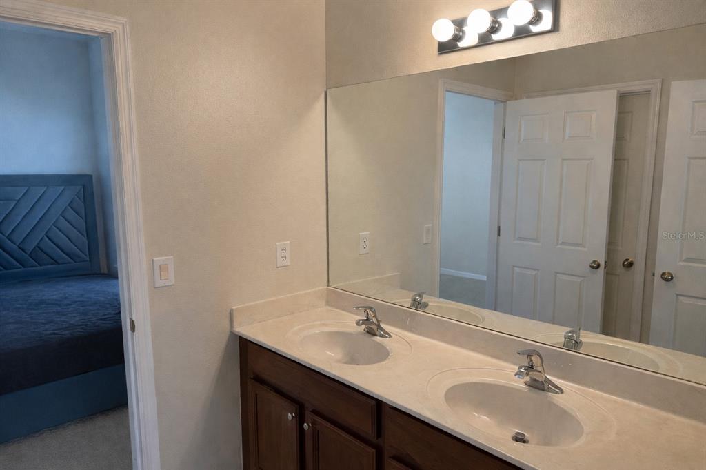 1007 Bennett Road Orlando, FL 32814 - Photo 16 of 25 a bathroom with a sink and a mirror