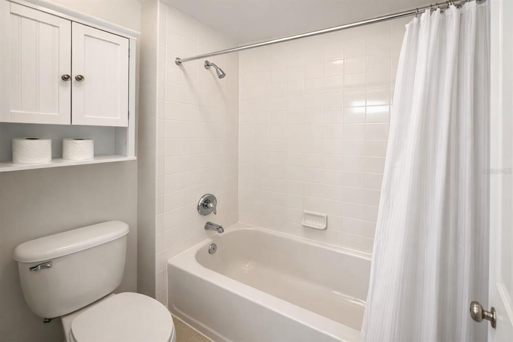 1007 Bennett Road Orlando, FL 32814 - Photo 17 of 25 a white toilet sitting next to a bath tub