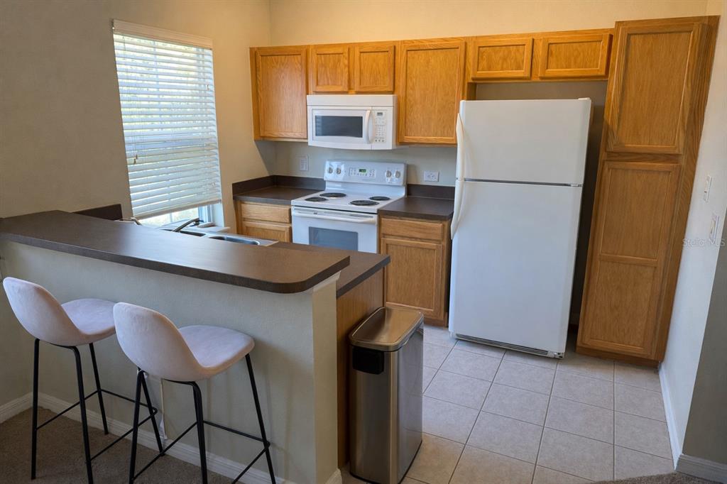 1007 Bennett Road Orlando, FL 32814 - Photo 20 of 25 a kitchen with stainless steel appliances a refrigerator a stove a sink and a refrigerator