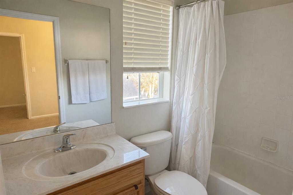 1007 Bennett Road Orlando, FL 32814 - Photo 24 of 25 a bathroom with a sink toilet a mirror and shower