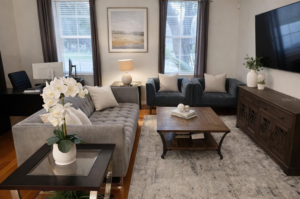 1007 Bennett Road Orlando, FL 32814 - Photo 5 of 25 a living room with furniture a flat screen tv and a window