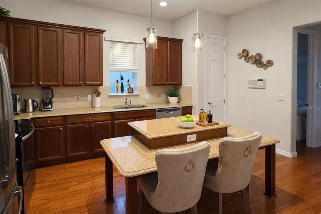 1007 Bennett Road Orlando, FL 32814 - Photo 8 of 25 a kitchen with a sink cabinets and wooden floor