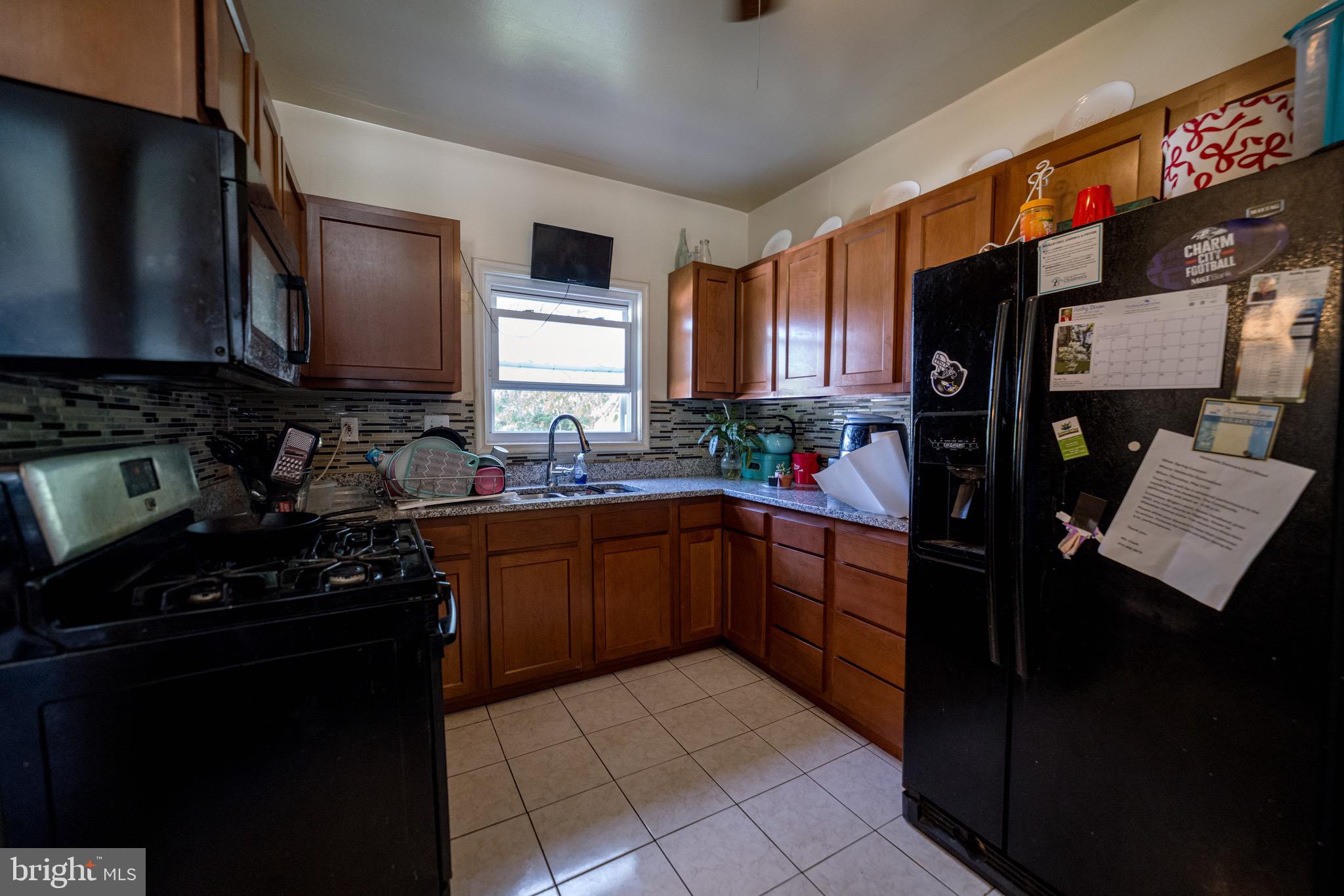 4125 Ronis Road Pikesville, MD 21208 - Photo 28 of 40 a kitchen with a sink stove and refrigerator