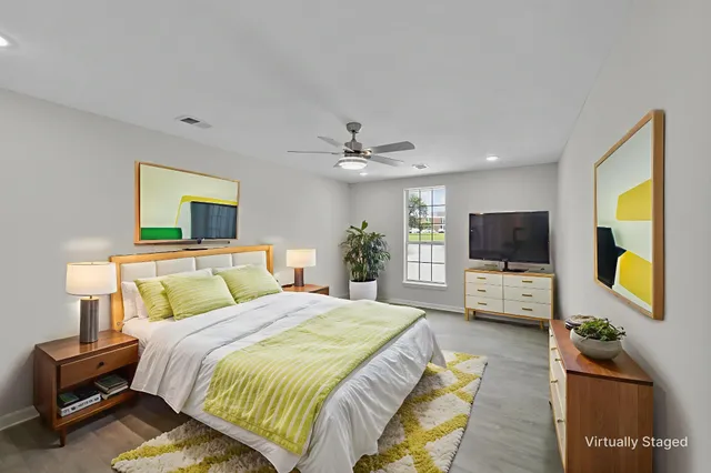 a bedroom with a bed and a flat screen tv