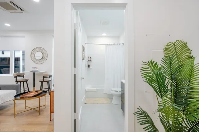 a bathroom with a sink a toilet and a shower